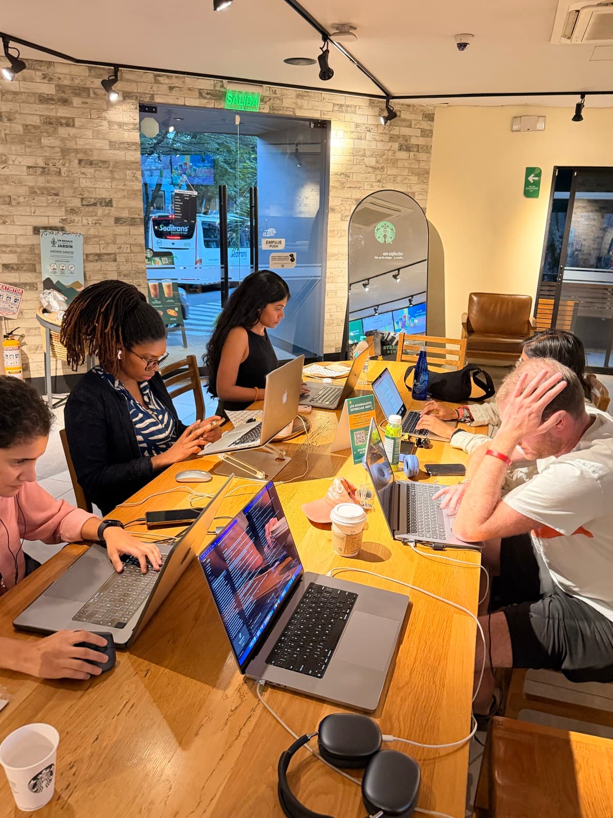 A room of people heads down at their work.